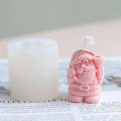 a candle and a pink figurine sitting on top of a newspaper