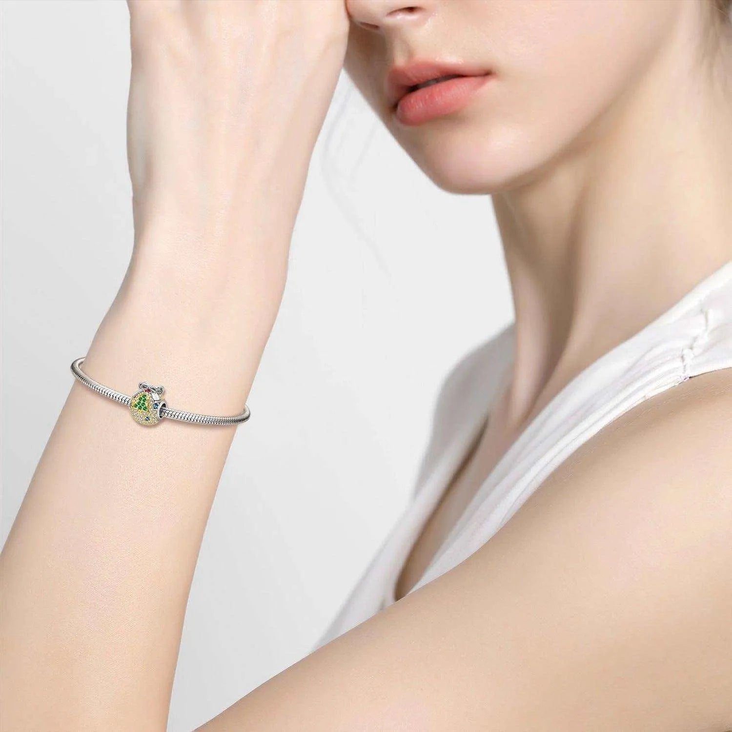 a woman wearing a bracelet with a cross on it