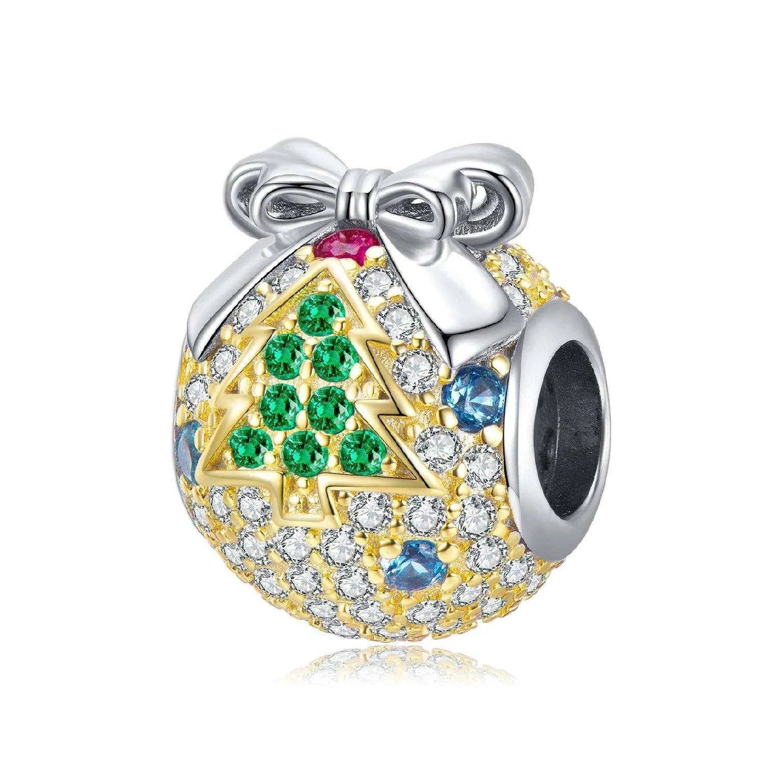 a charm with a christmas tree on it