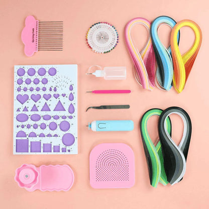 a variety of craft supplies laid out on a pink surface