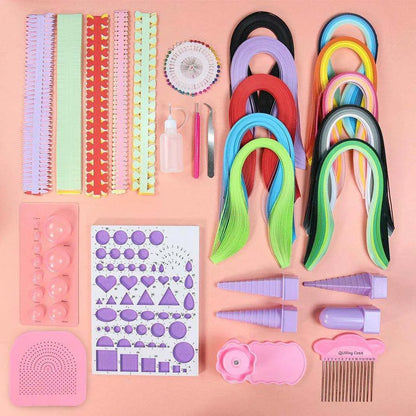 a variety of craft supplies laid out on a pink surface