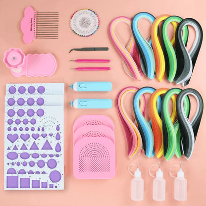 a variety of crafting supplies laid out on a pink surface