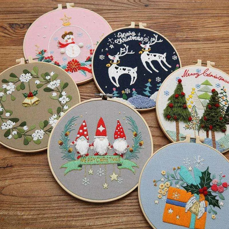 a group of embroidered christmas designs on a wooden table