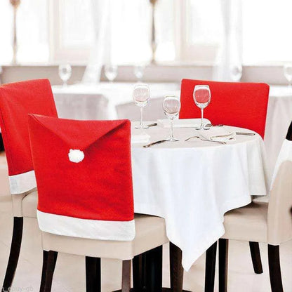 a table with a white table cloth and red chairs