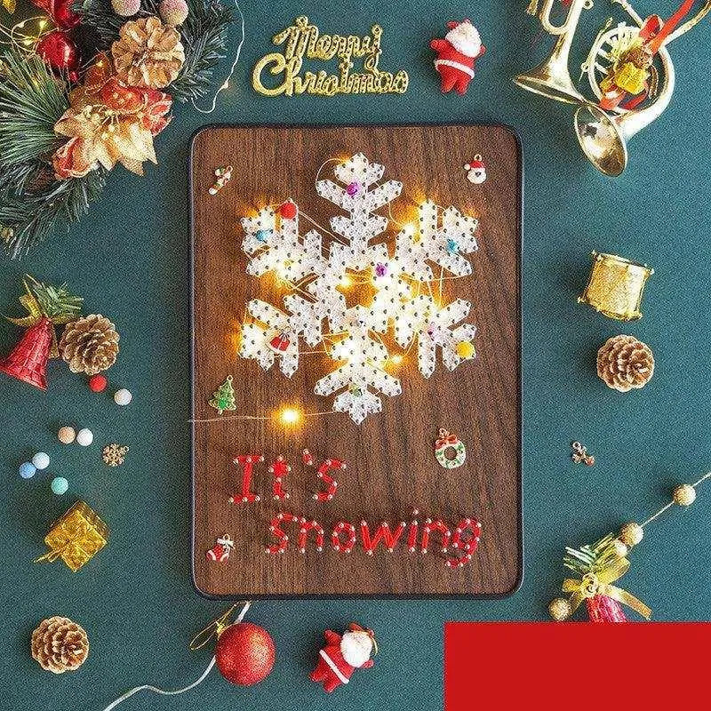 a wooden board with a snowflake on it surrounded by christmas decorations