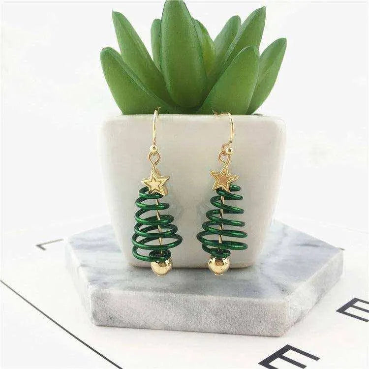 a pair of green and gold christmas tree earrings