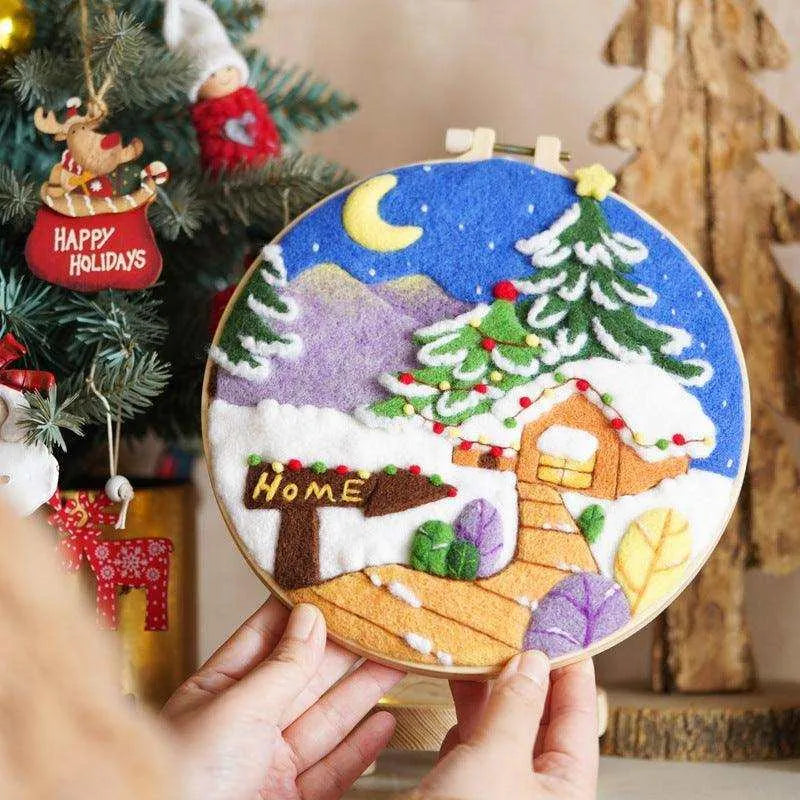 a person holding a christmas ornament in front of a christmas tree