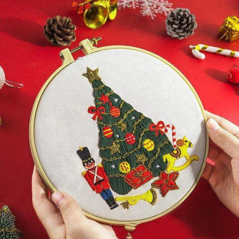 a hand embroidered christmas tree on a red surface