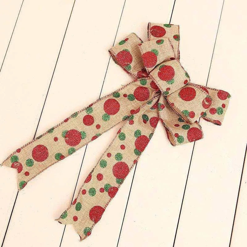 a red and green polka dot bow on a white background