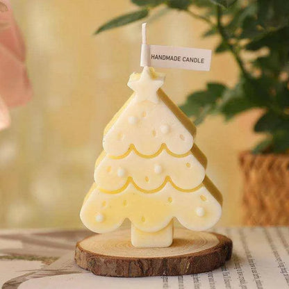 a small white christmas tree candle on a table