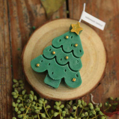 a green christmas tree cookie sitting on top of a wooden plate