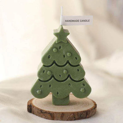 a green ceramic christmas tree on a wooden stand