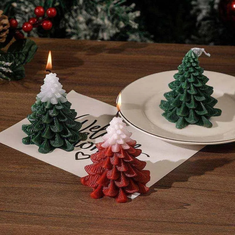 a couple of small christmas trees sitting on top of a table