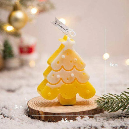 a small yellow and white christmas tree on a wooden stand