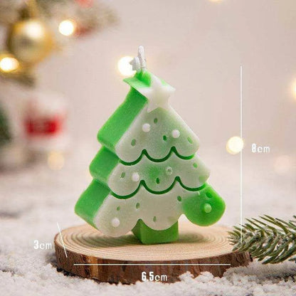 a small green and white christmas tree candle