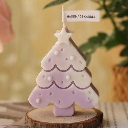 a small pink christmas tree on a wooden stand