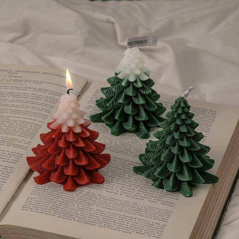 a book with a candle in the shape of a christmas tree