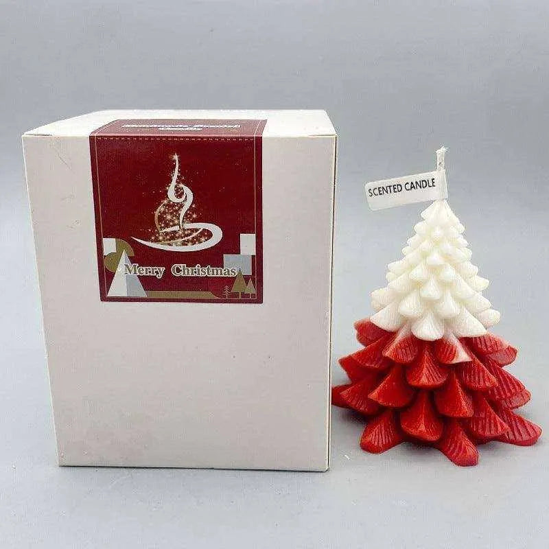 a small white and red christmas tree next to a box