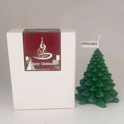 a small christmas tree sitting next to a white box