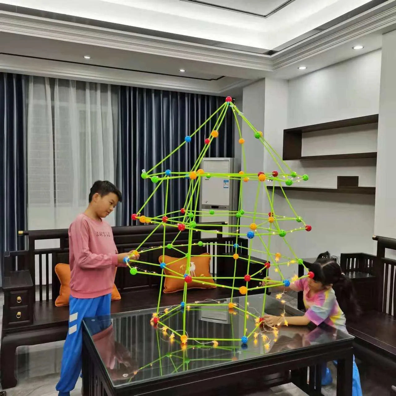 a man and a little girl playing with a christmas tree