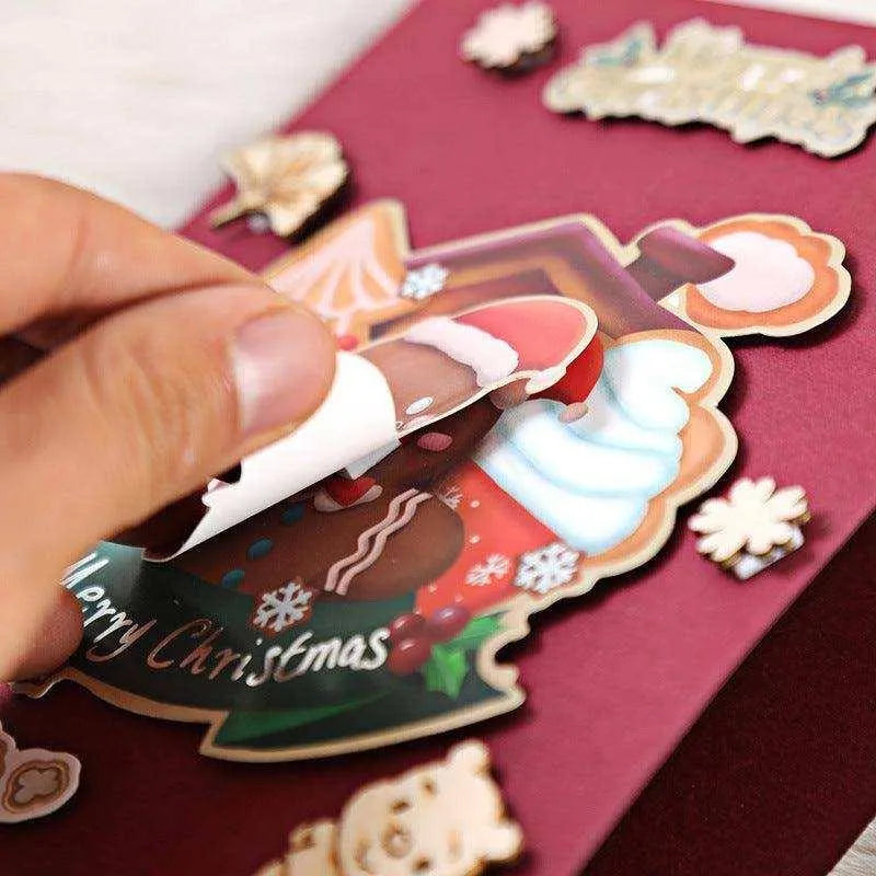 a hand holding a pen over a christmas card