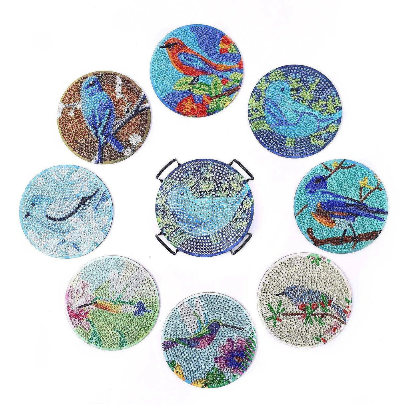 a group of nine coasters with birds painted on them