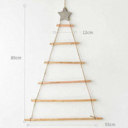 a wooden christmas tree hanging on a wall