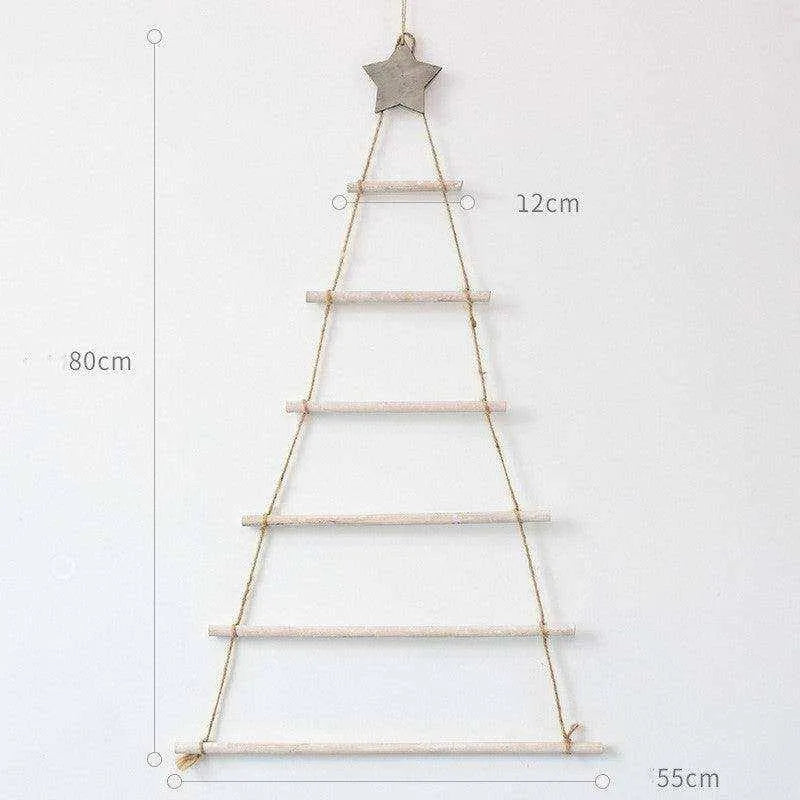 a christmas tree hanging on a wall next to a ruler