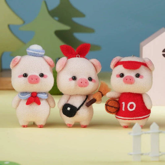 Handcrafted pink pig made with needle felting kit displayed as a pendant or keychain