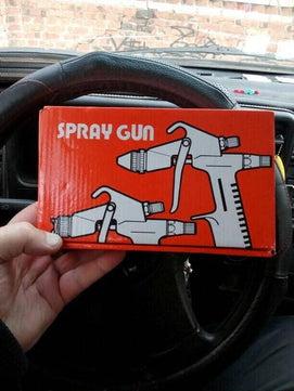 Close-up of adjustable controls on paint sprayer gun airbrush